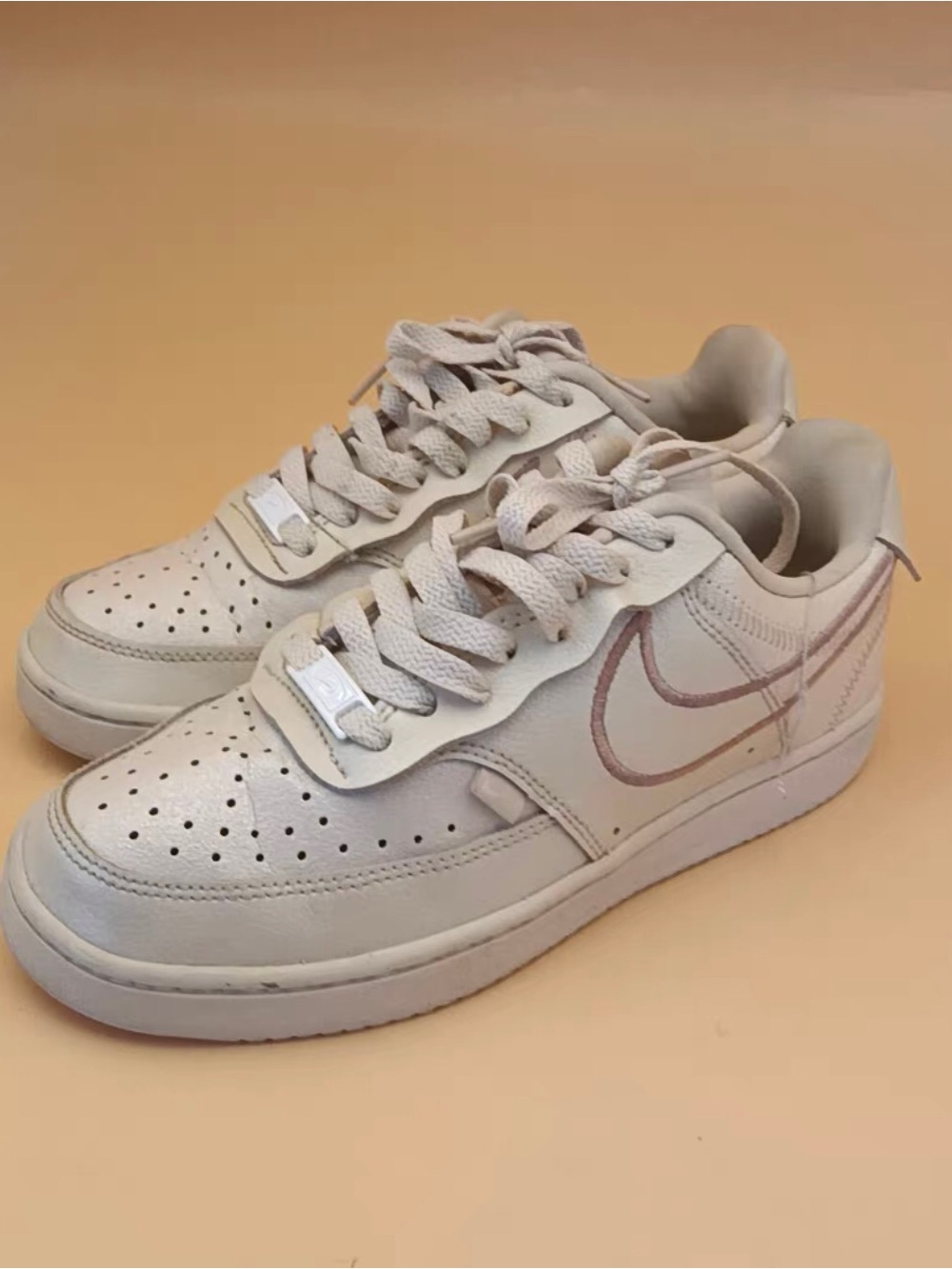 Nike Women's Low-Top Sneakers in Cream with Light Pink Swoosh